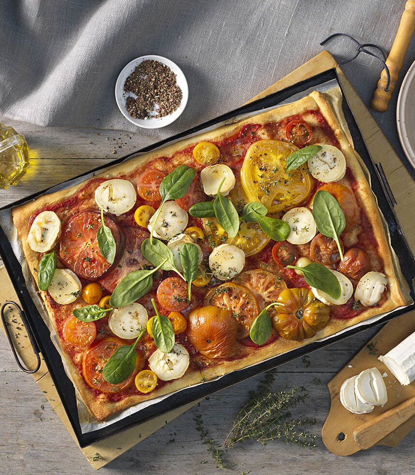 Pizza mit Ziegenkäse und bunten Tomaten